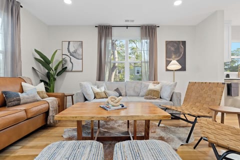 Bright open living room with modern seating, natural light, and space to relax
