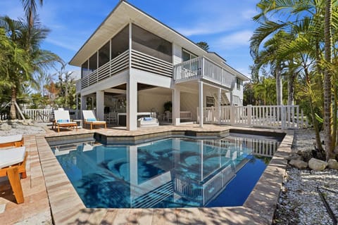 The ultimate backyard retreat - take a dip in the heated pool, relax in the hot tub, or gather under the cabana for drinks and conversation. With plenty of lounge seating and tropical surroundings, this space is perfect for making vacation memories together.