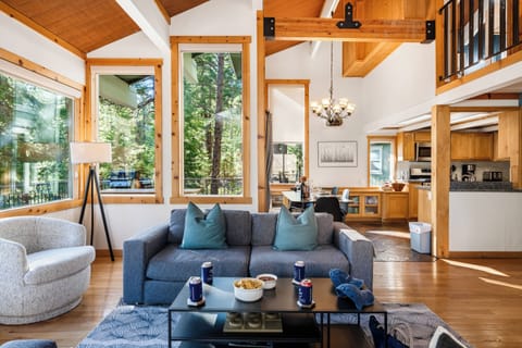 Open-plan living & dining area with sleek furnishings and seamless indoor-outdoor flow.