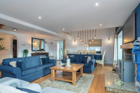 The large spacious living room with the log burning stove and dining area.