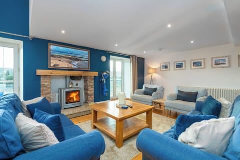 The large spacious living room with the log burning stove.