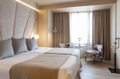 Wake up to daylight and cozy seating by the window.