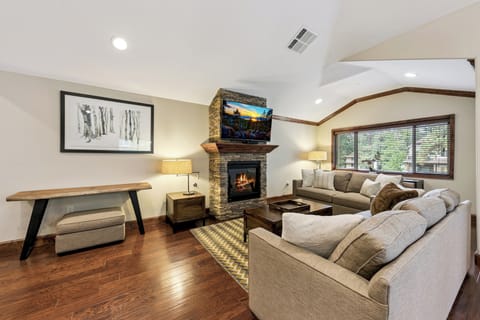 Sink into plush sectional seating by your cozy stone fireplace, where warm flames create the perfect ambiance for relaxing evenings together.