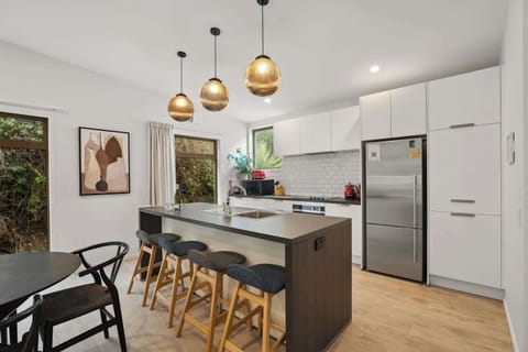 Stylish kitchen with breakfast bar and pendant lighting