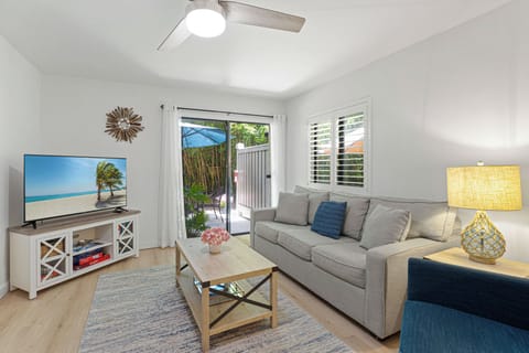 Natural light fills the room through sliding glass doors that open to a private outdoor area, creating a seamless indoor–outdoor flow.