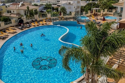 Dive into holiday vibes at the sparkling pool with friends.