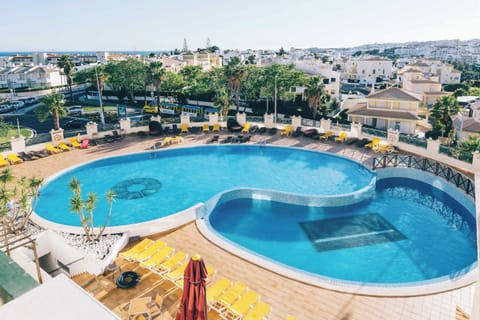 Take in the panoramic pool scene from above in sunshine.