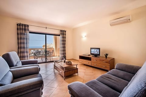 Unwind on plush sofas with fresh sea-breeze balcony views.