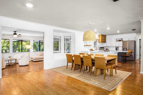 Seamless flow from kitchen to dining to living area.