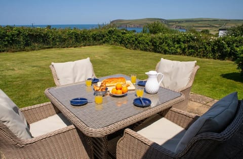 Patio with table and chairs and distant sea views