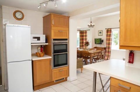 Kitchen with fridge/freezer, microwave and built-in electric oven