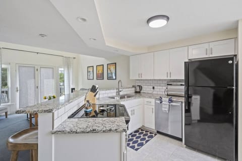 Enjoy cooking and conversation in this airy kitchen overlooking the living space.