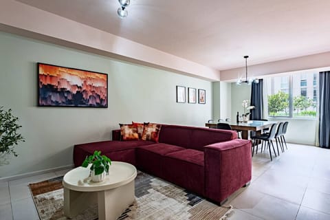 Open-concept living and dining area with a sofa, a coffee table, and a view of the dining table