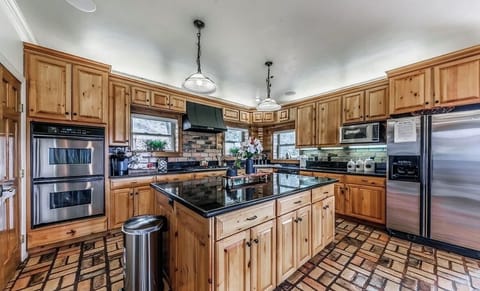 Kitchen with double oven and granite and stainless steel dining