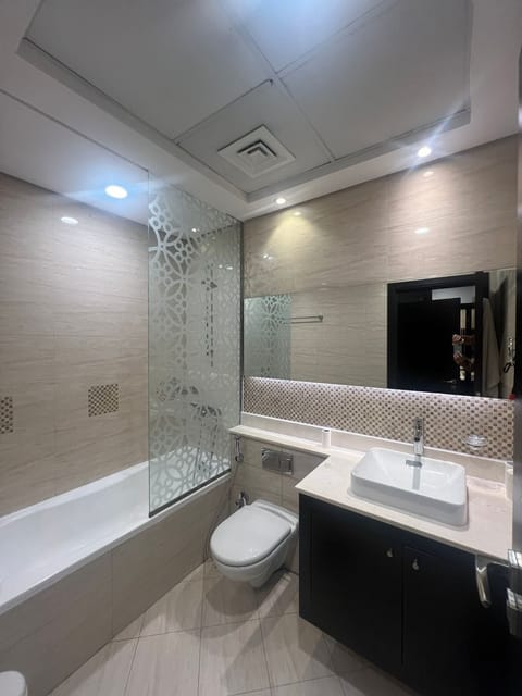 Separate tub and shower, hair dryer, slippers, towels