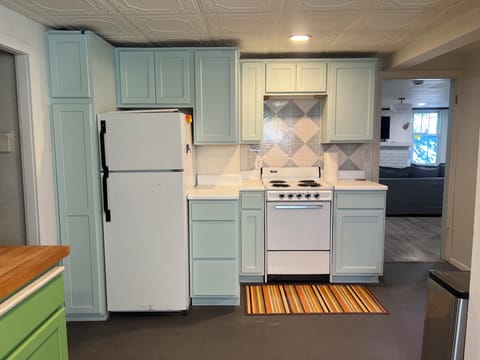 full kitchen with fridge, freezer, oven and stovetop.