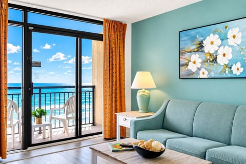 Floor-to-ceiling windows fill this oceanfront living room with natural light, plus a full-size sleeper sofa for extra guests.