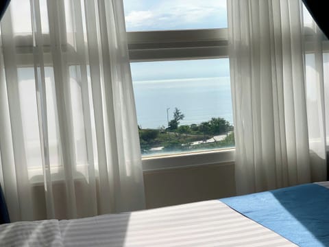 Deluxe Triple Room, Sea View | Minibar, in-room safe, desk, laptop workspace