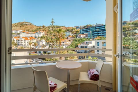 Sip morning coffee on the balcony with sweeping hillside views.