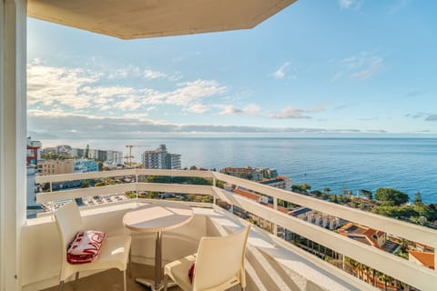 Linger over morning coffee on the balcony above the coastline.