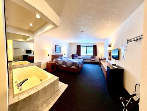 Adventure hard, relax easy. Our Whirlpool Suite features a queen bed, private whirlpool tub, recliner, and a cozy space to recharge after biking, boating, fishing, snowmobiling, or exploring Boulder Junction.