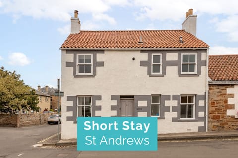Front of Earls Lodge in Earlsferry, white cottage with red-tile roof near Elie beach, Fife.