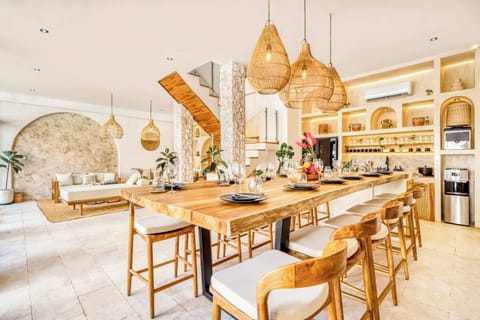 Shared meals, soft light, and natural textures create a welcoming dining experience