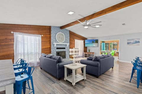 A large sectional, fireplace, smart television, and open connection to the dining room and kitchen make this the main gathering space.