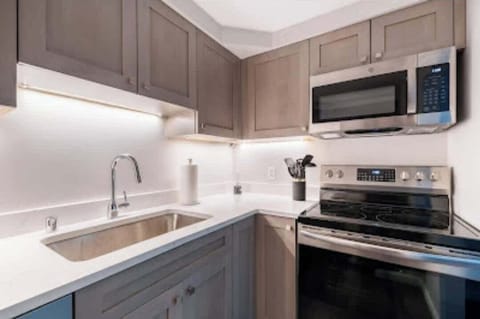 Sink, stove and microwave in kitchen.