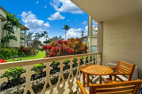 Sip your morning coffee on your private balcony overlooking vibrant tropical gardens and swaying palms under endless blue skies.