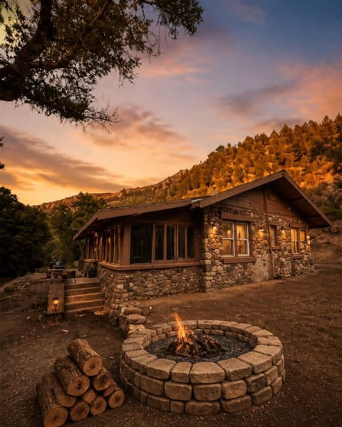 Outside view of the cabin, firepit and canyon walls.