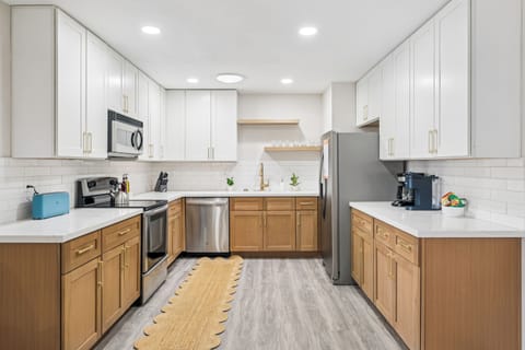 The kitchen has been recently renovated with a modern touch and stainless steel appliances