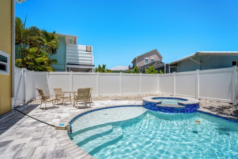 Relax by the pool on the patio with convenient outdoor table seating.