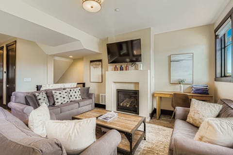 Unwind in your bright, beautifully designed living space with plush seating, a warm fireplace, and modern entertainment—your perfect home base for relaxation and connection.