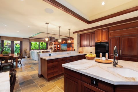 Gourmet kitchen with quartzite counters, premium appliances, and walk-in pantry.