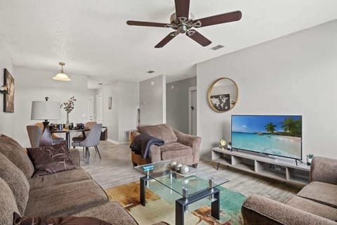 Living Room offers a comfortable sofa, love seat, & chair to lounge in while watching the 50" Roku Smart TV. 