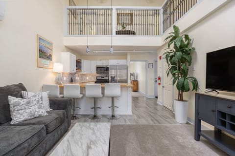 View from the front door showing living room, kitchen, first floor king bedroom door and second level above
