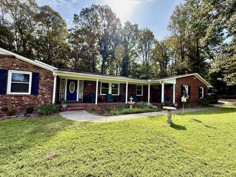Spacious front yard with open lawn, perfect for outdoor activities.