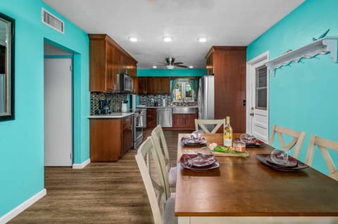 Discover the unique character of this Seminole kitchen with its warm wood tones, sleek stainless steel accents, and a touch of coastal flair in the vibrant teal details.