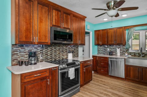 Start your day in this bright and inviting kitchen. With its clean countertops, ample natural light, and modern amenities, it's a pleasure to cook and gather in this space.