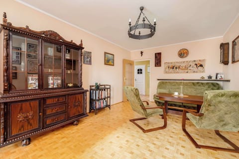 Bright, spacious interior with an elegant display cabinet and a large table invites shared meals and long conversations in a homely atmosphere.