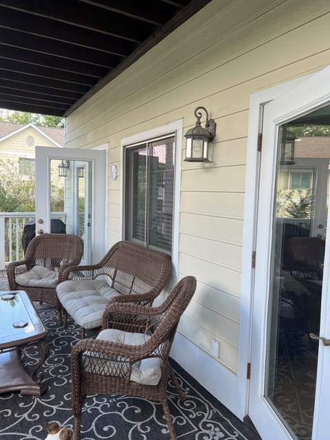 Downstairs deck with balcony and outdoor grill