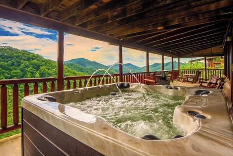Soak in the private hot tub while taking in the breathtaking mountain scenery.