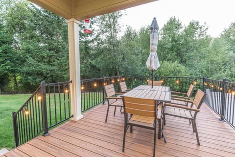 Step outside onto the expansive deck, perfect for sipping coffee in the morning or enjoying evening conversations surrounded by peaceful scenery.