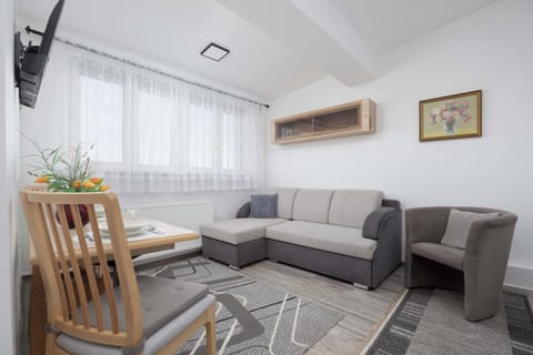 Relax in the stylish living room with a comfortable sofa and modern decor.