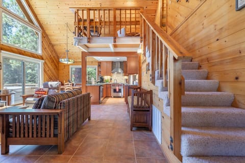 Step into the main living area, where natural wood surrounds you, creating a warm, cabin-like atmosphere.