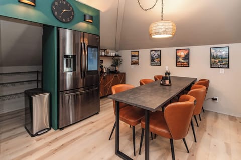 Dine in style with cushy mid-century chairs and a dimmable rattan chandelier.