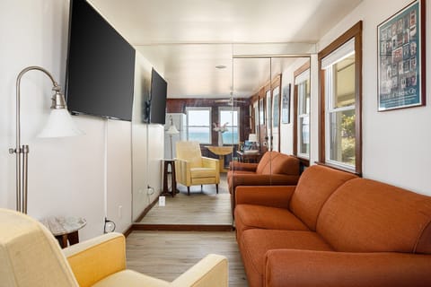 Bright living room w/ comfy seating & big windows that frame peaceful lake views.