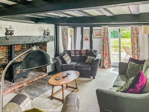 Cosy lounge with patio doors to the garden | Willow Cottage - Framlingham Retreats, Framlingham