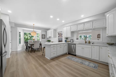 Modern kitchen with sleek finishes and generous breakfast bar.